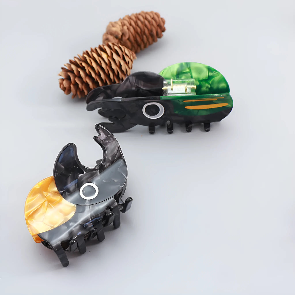 Handmade green and orange beetle grip hair accessory with white cartoon caterpillar design