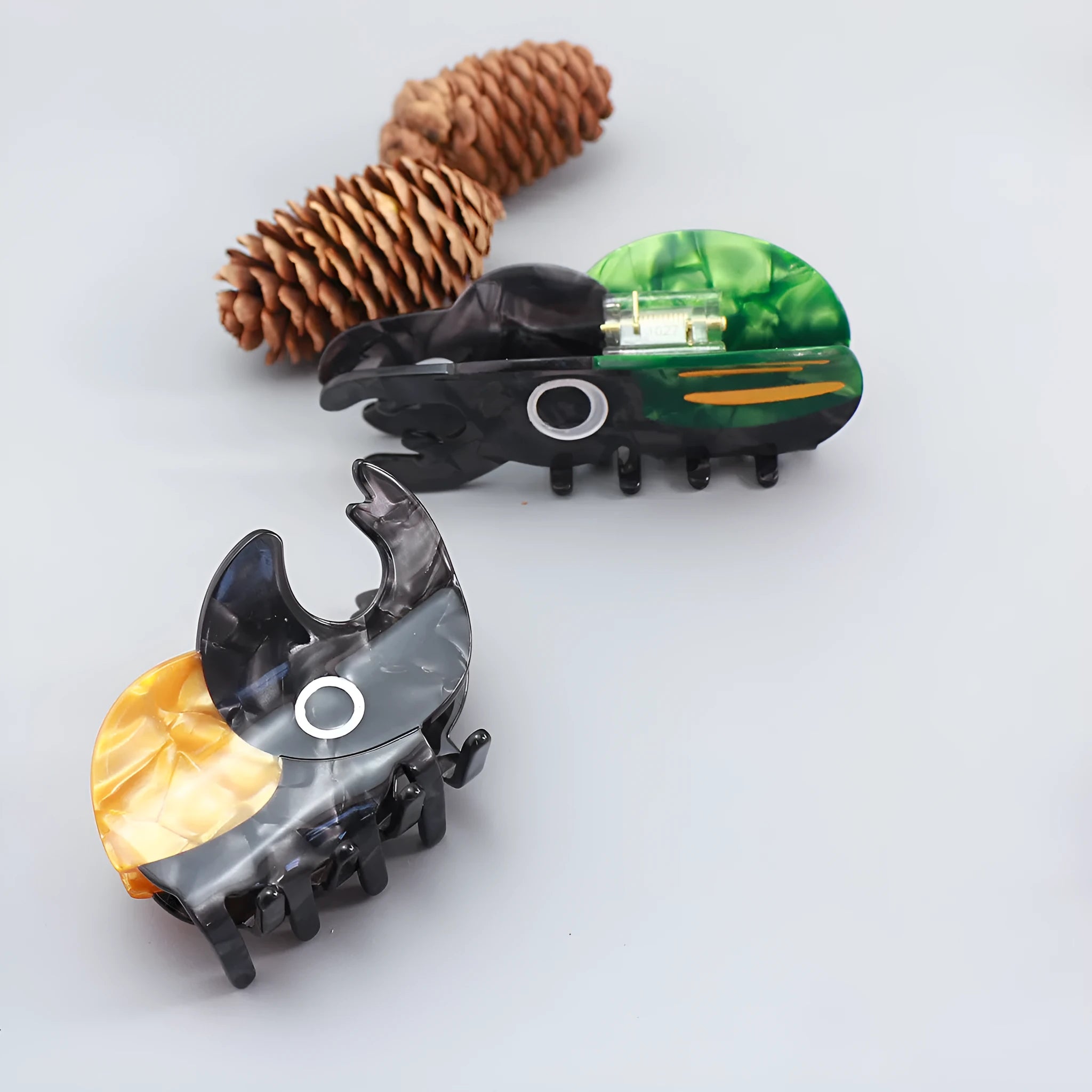 Handmade green and orange beetle grip hair accessory with white cartoon caterpillar design