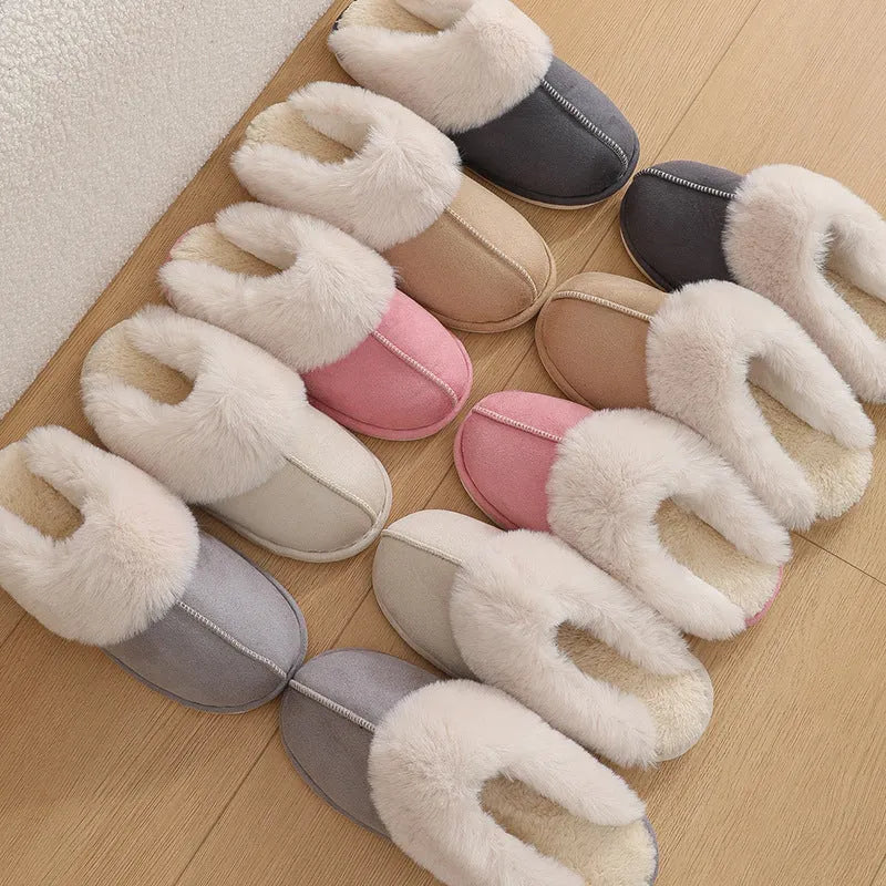 A pair of round-toe flat-heel plush slippers with stitching detail, shown in one of five available colours.