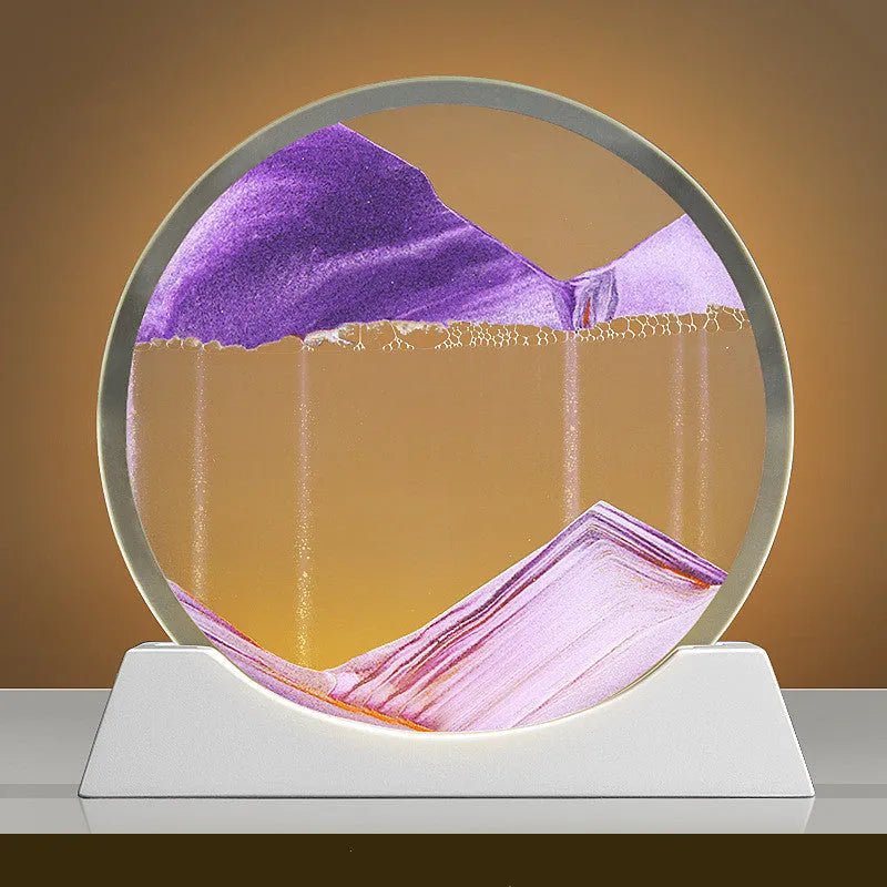 12-inch tall rotary quicksand night lamp with coloured sand in a modern glass base on a desktop.