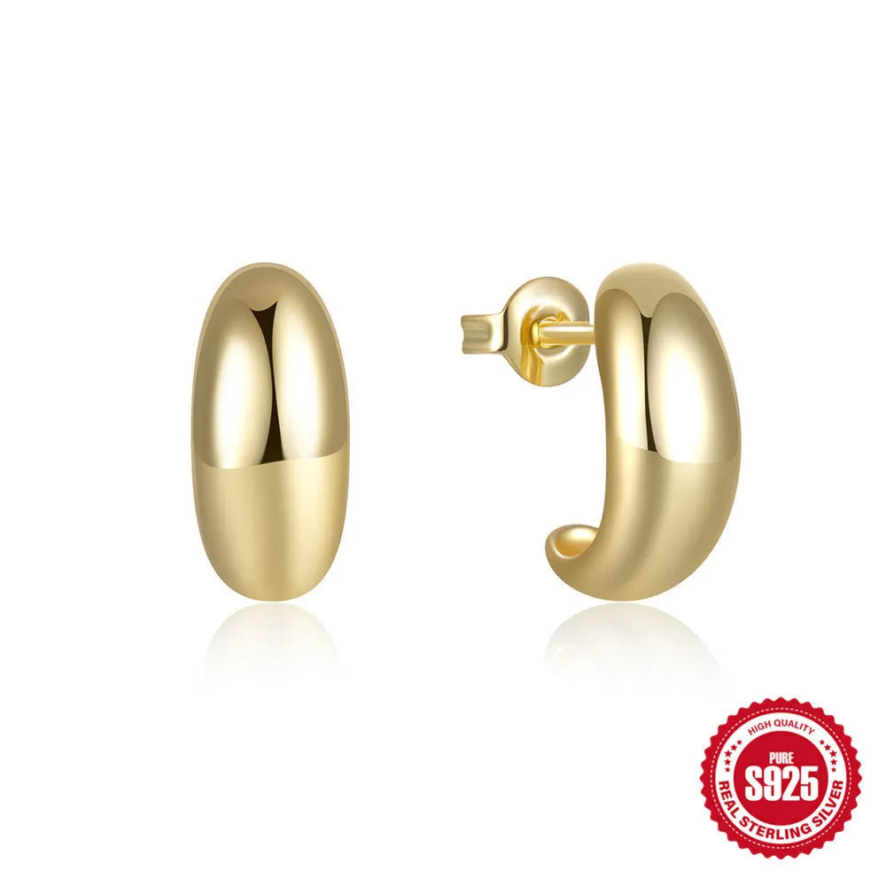 A single glossy C-shaped sterling silver stud earring on a plain background, showing gold and silver finish options.