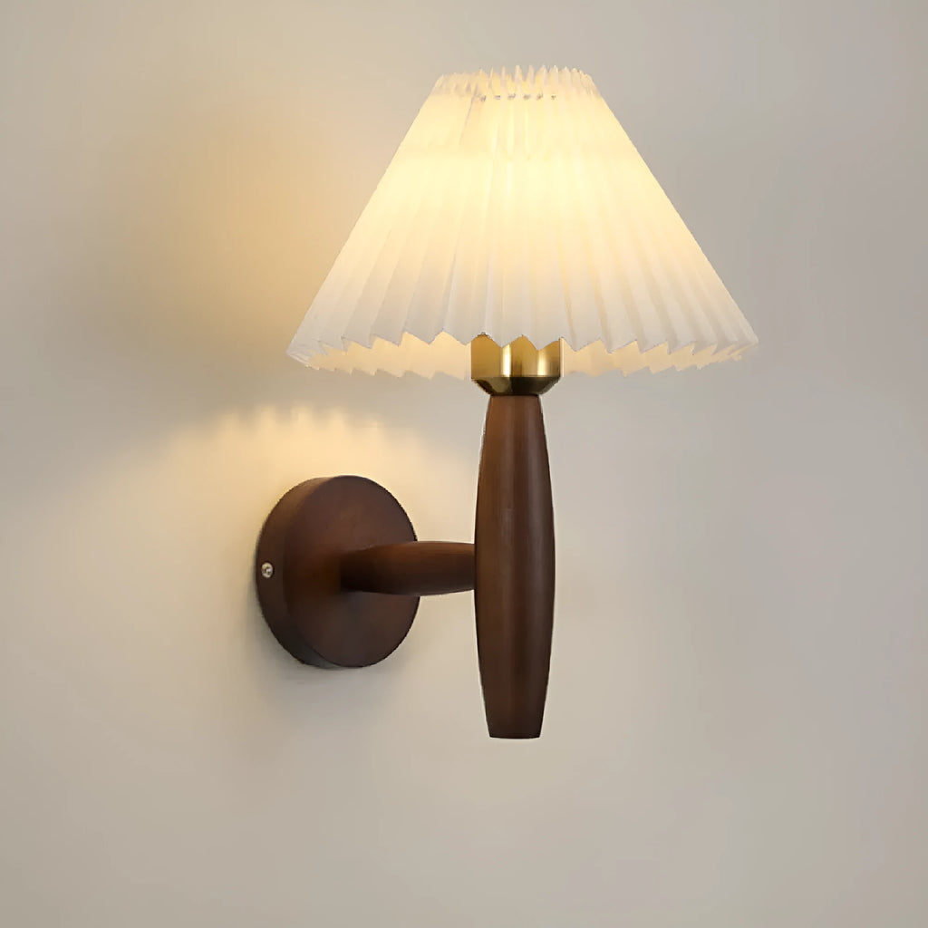 Retro wooden wall lamp with fabric shade in walnut finish mounted beside a bed.