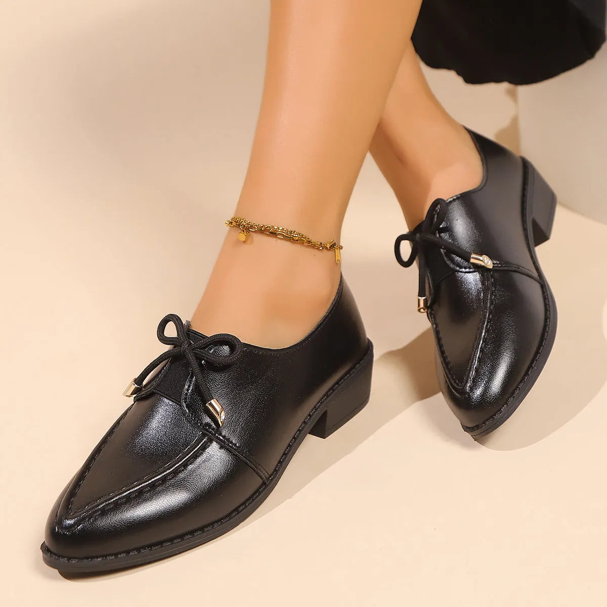 Women's brown PU leather slip-on shoe with a large bow on the pointed toe.