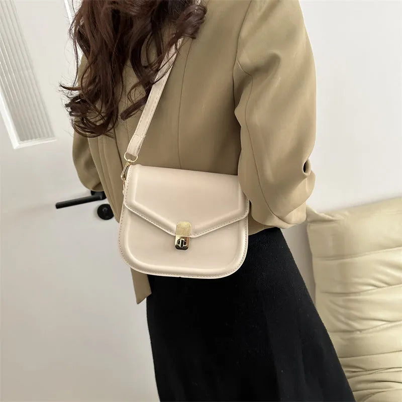 Soft PU leather messenger bag with clamshell opening in a horizontal square shape.