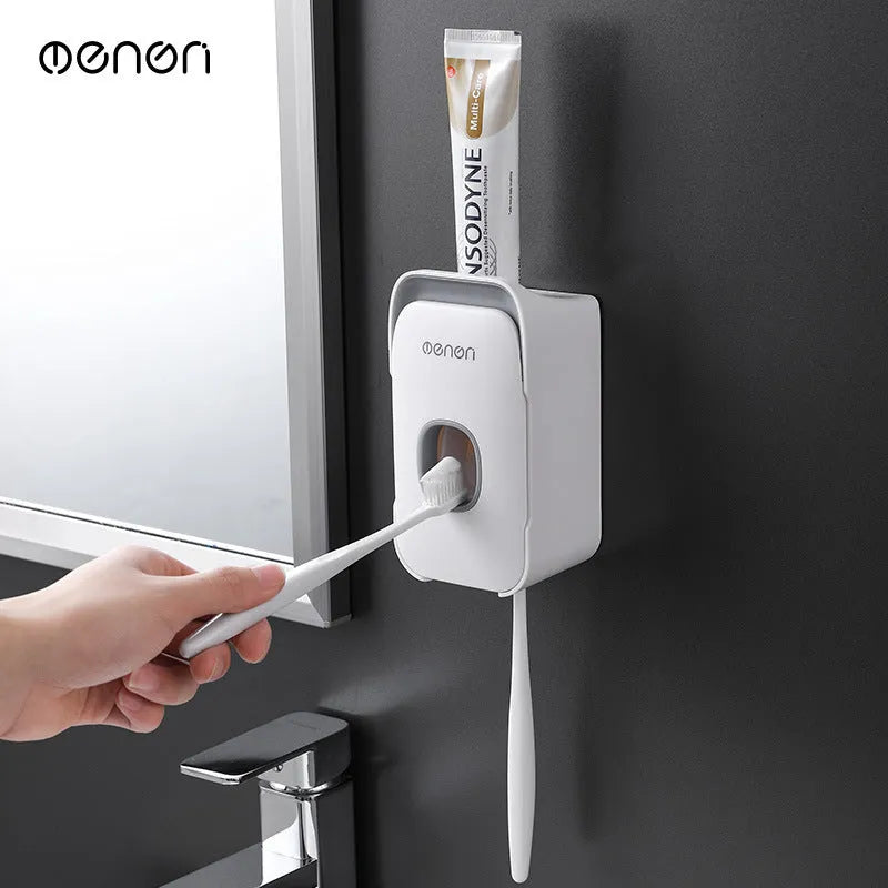 Automatic toothpaste dispenser in ABS plastic with suction cup wall mount in blue, grey, and pink colour options