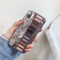 Silicone iPhone case with an eye shadow colour palette design, shown in Flesh and Grey colours.