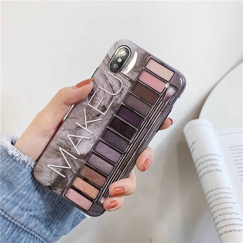 Silicone iPhone case with an eye shadow colour palette design, shown in Flesh and Grey colours.