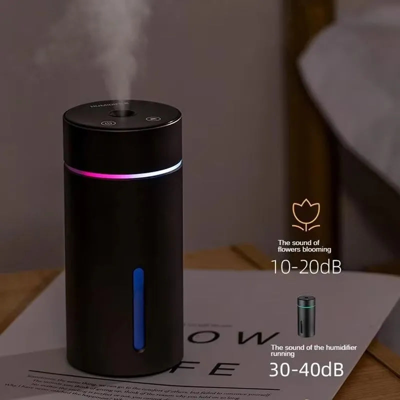 Aluminium portable car air humidifier and essential oil diffuser with multi-colour light on a black USB cable.