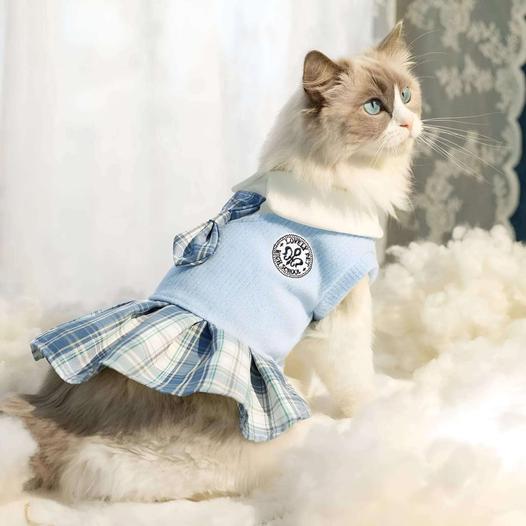 A pink tartan skirt with princess styling designed for a small dog to wear.