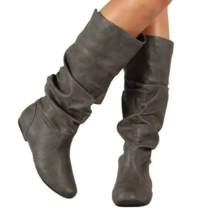 Women's flat ankle boots in black with a round toe, slip-on design, and high cylinder cut.