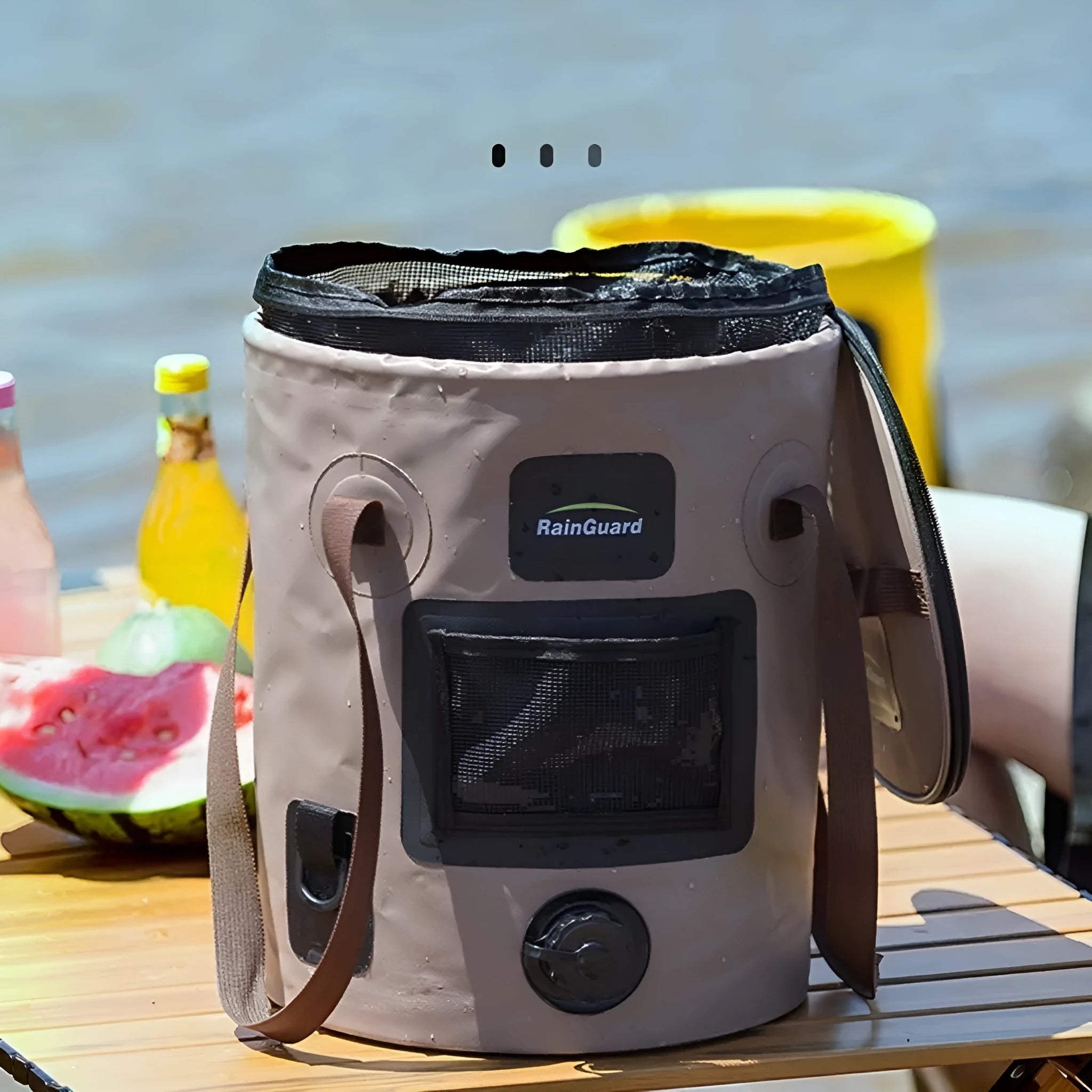 Lemon yellow folding plastic fishing bucket with a 25L capacity, shown next to a coral coloured version with a built-in mesh net pocket.