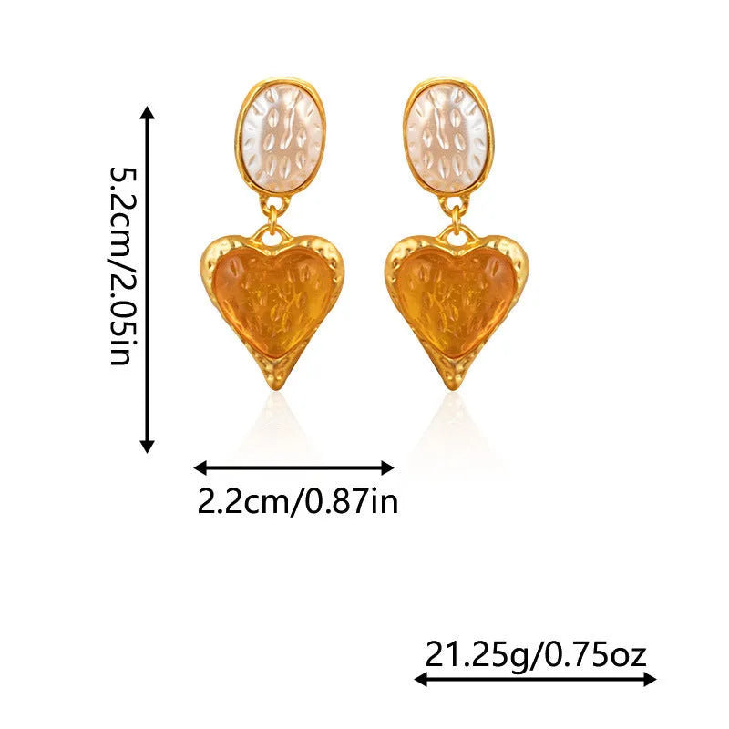 A pair of oval-shaped love heart stud earrings with a pleated surface, shown in one of four colour options.