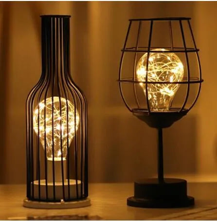 Minimalist hollow wrought iron table lamp in red wine glass style with warm white LED light.
