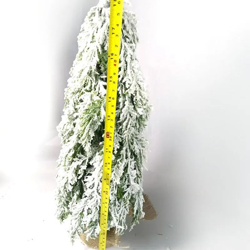 Small 24-inch artificial Christmas tree with snow-spray branches and built-in lights for desktop decoration