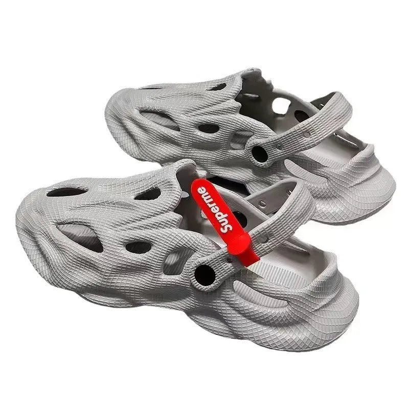 Pair of grey closed-toe EVA coconut slippers on a solid background, showing the frosted finish and cap style.