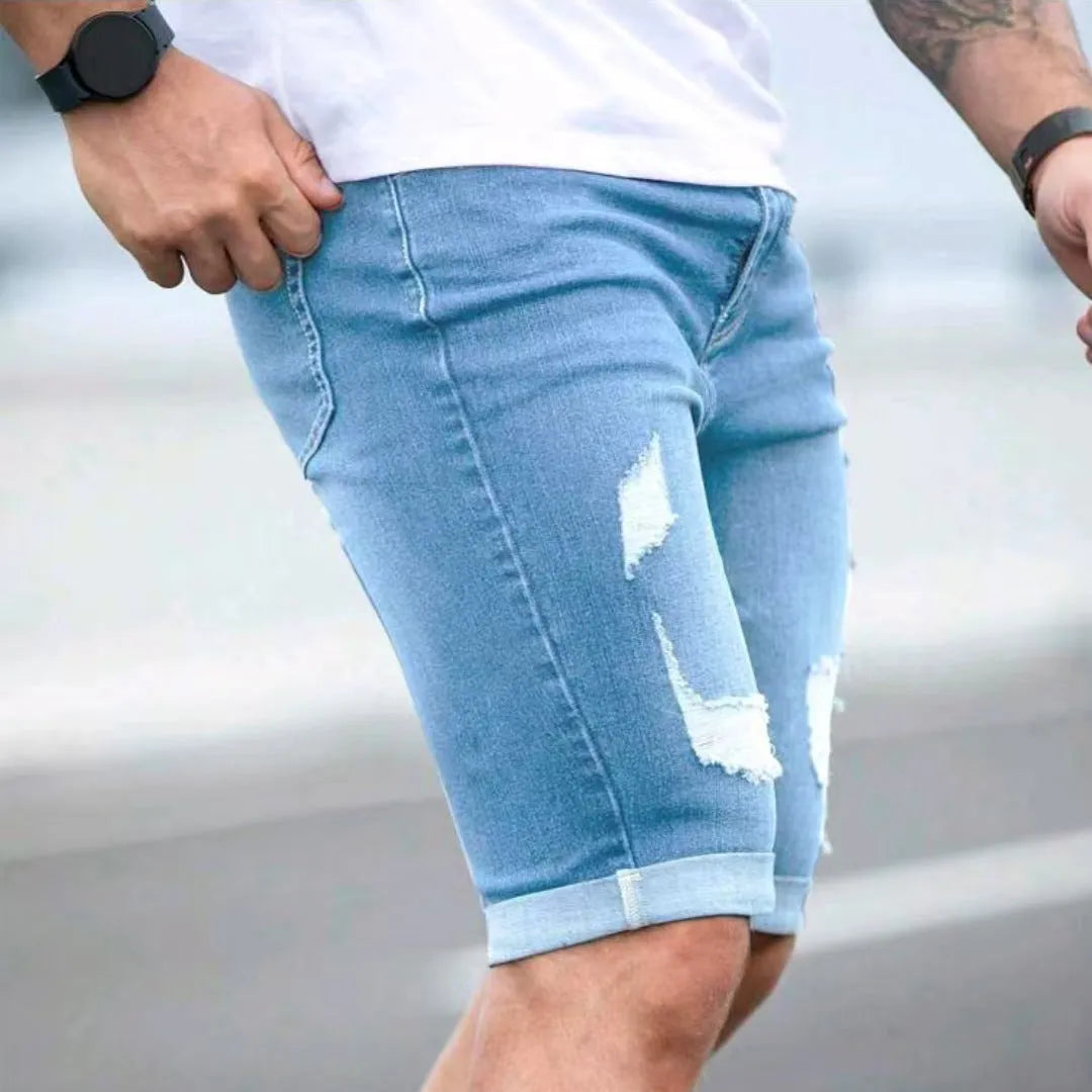 Sky blue distressed denim shorts with low-rise waist and zip fly closure
