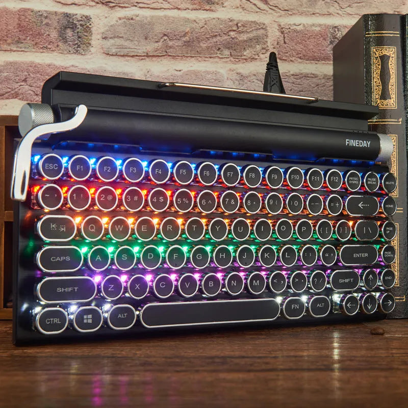 Black retro-style mechanical keyboard with typewriter keycaps and multi-colour backlighting on a desk.