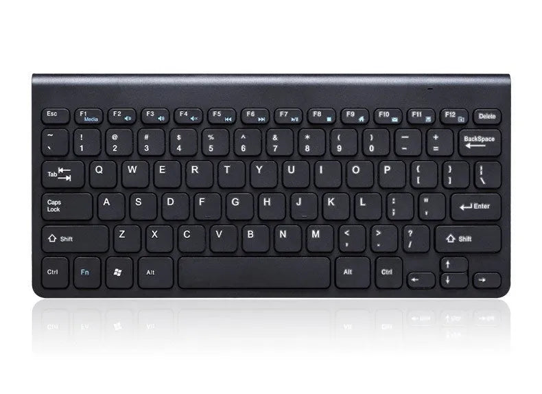 Black and white wireless keyboard and mouse set on a wooden desk