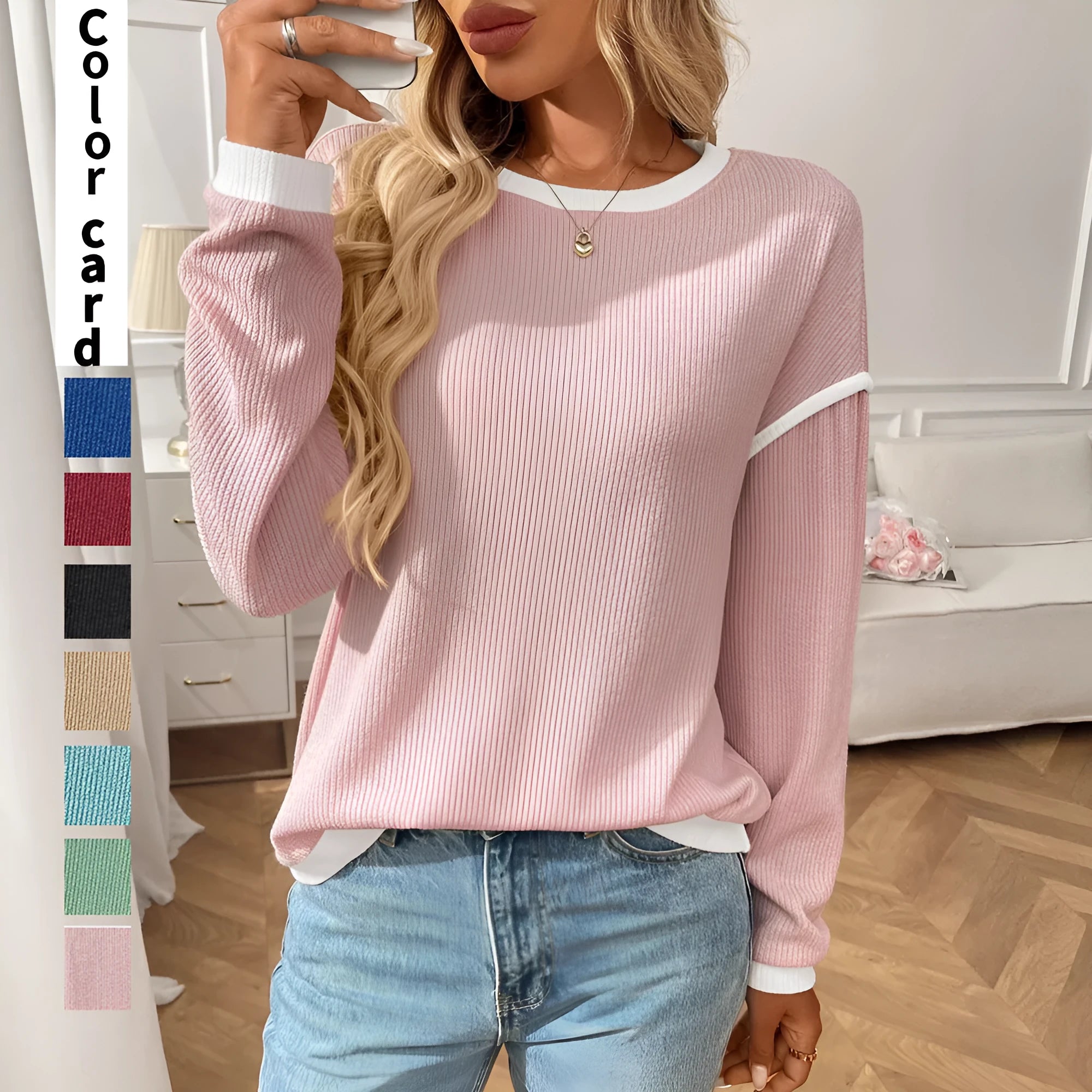 Women's loose round neck long sleeve polyester top shown in a light colour on a hanger.