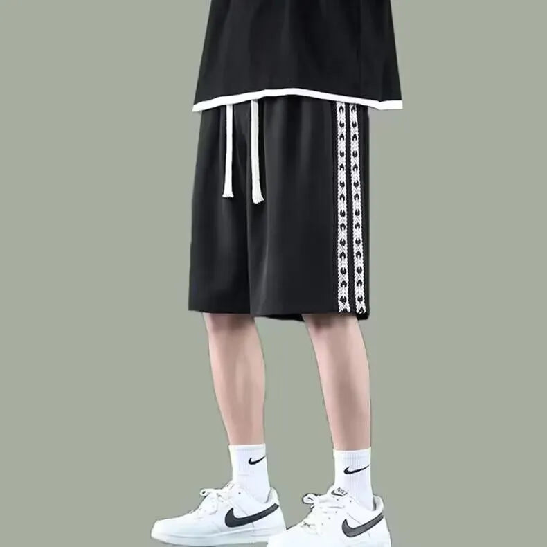 Men's black loose-fit baggy track pants with micro-elasticity fabric and sport styling