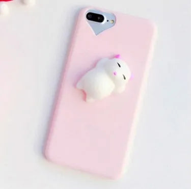 Soft silicone iPhone case with a raised 3D cartoon cat design, shown in pink.