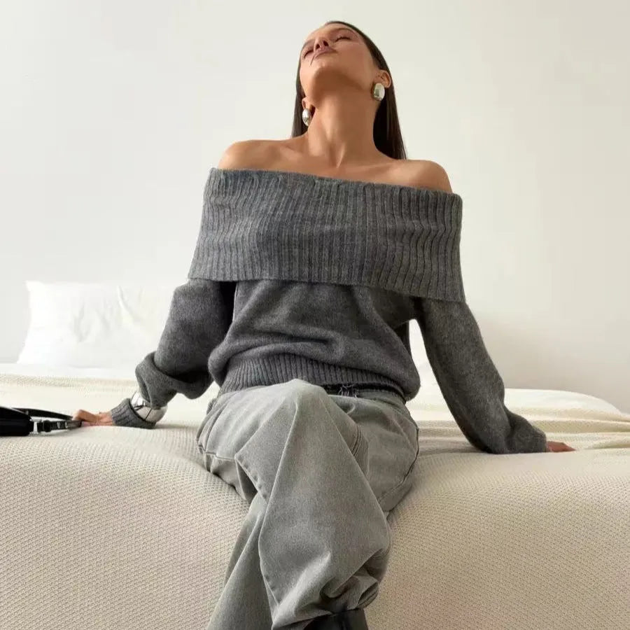 Grey off-the-shoulder sweater with a strapless neckline and a raised 3D pattern across the front.