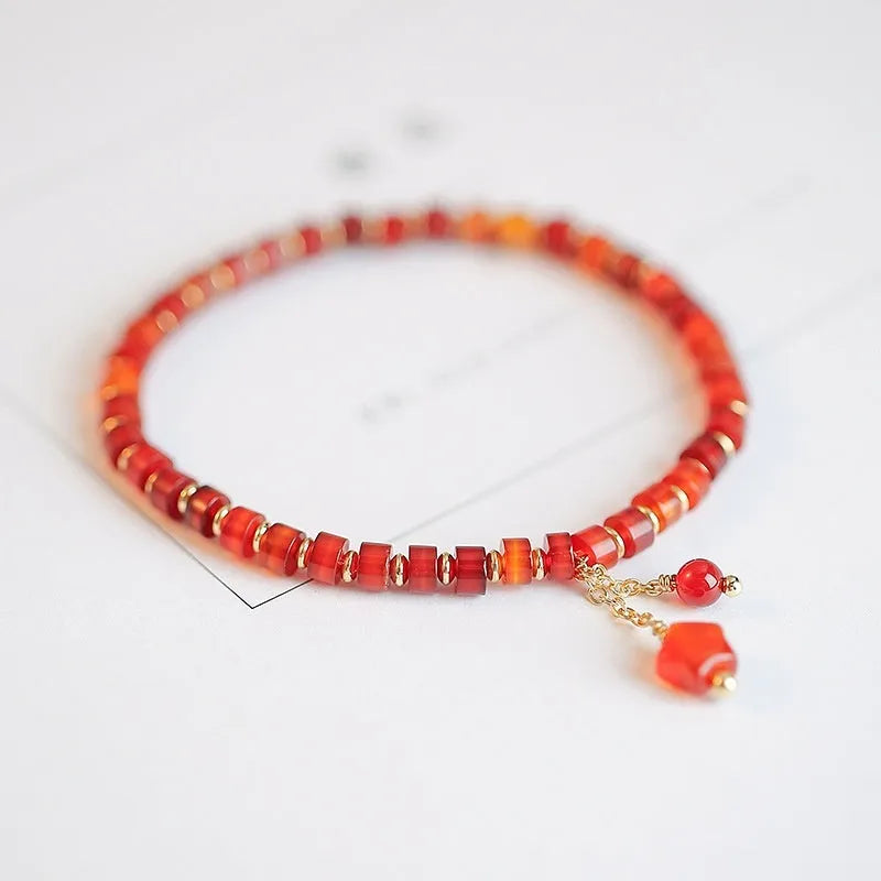 Natural red agate hand-woven bracelet showing diamond-shaped beads in ethnic woven pattern