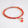 Natural red agate hand-woven bracelet showing diamond-shaped beads in ethnic woven pattern