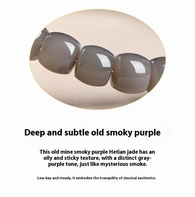 Smokey violet Hetian jade straight cut beaded bracelet on a wrist.