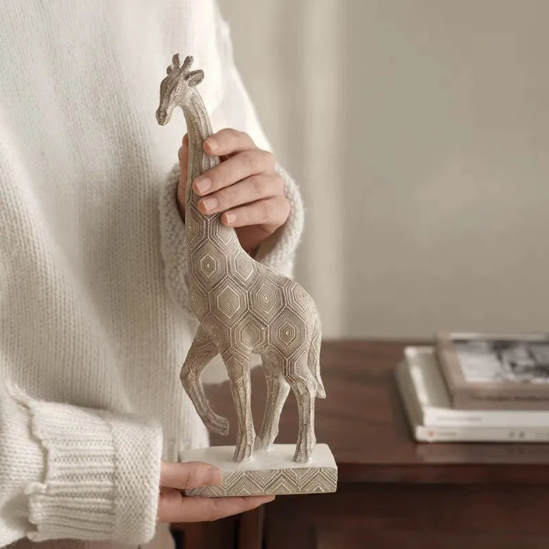 Wood colour giraffe-shaped resin ornament on a shelf, showing European style design.