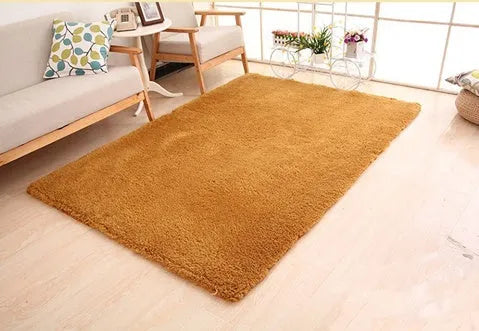 White rectangular fluffy plush carpet with non-slip dot backing on a wooden floor