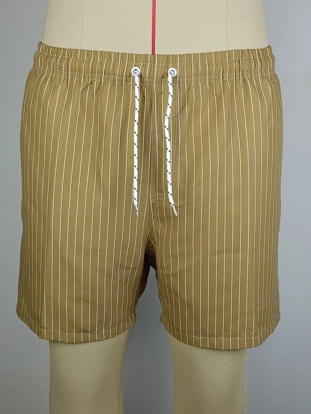 Navy blue striped beach shorts with straight legs on a mannequin.
