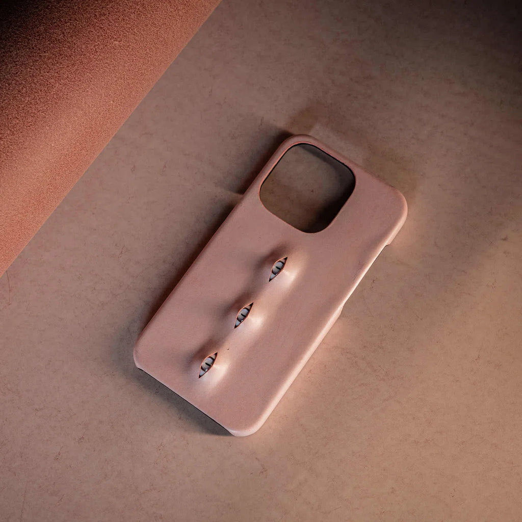 Handmade waxed cowhide leather eye phone case in pink with three-eye vertical design