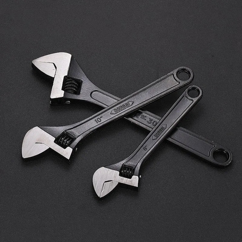 High-carbon steel adjustable spanner with black finish on a grey background.