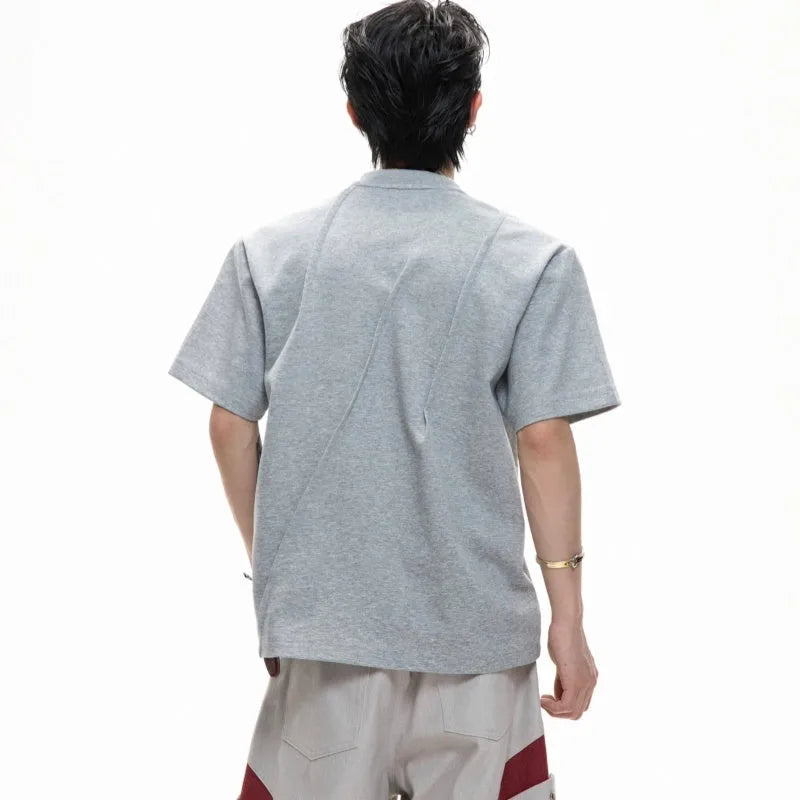 Men's loose fit grey cotton T-shirt with three-dimensional pleated detail on the front.