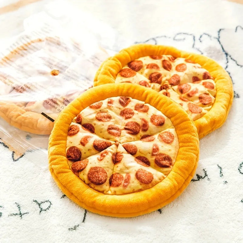Yellow pizza slice shaped plush squeaky dog chew toy on a white background