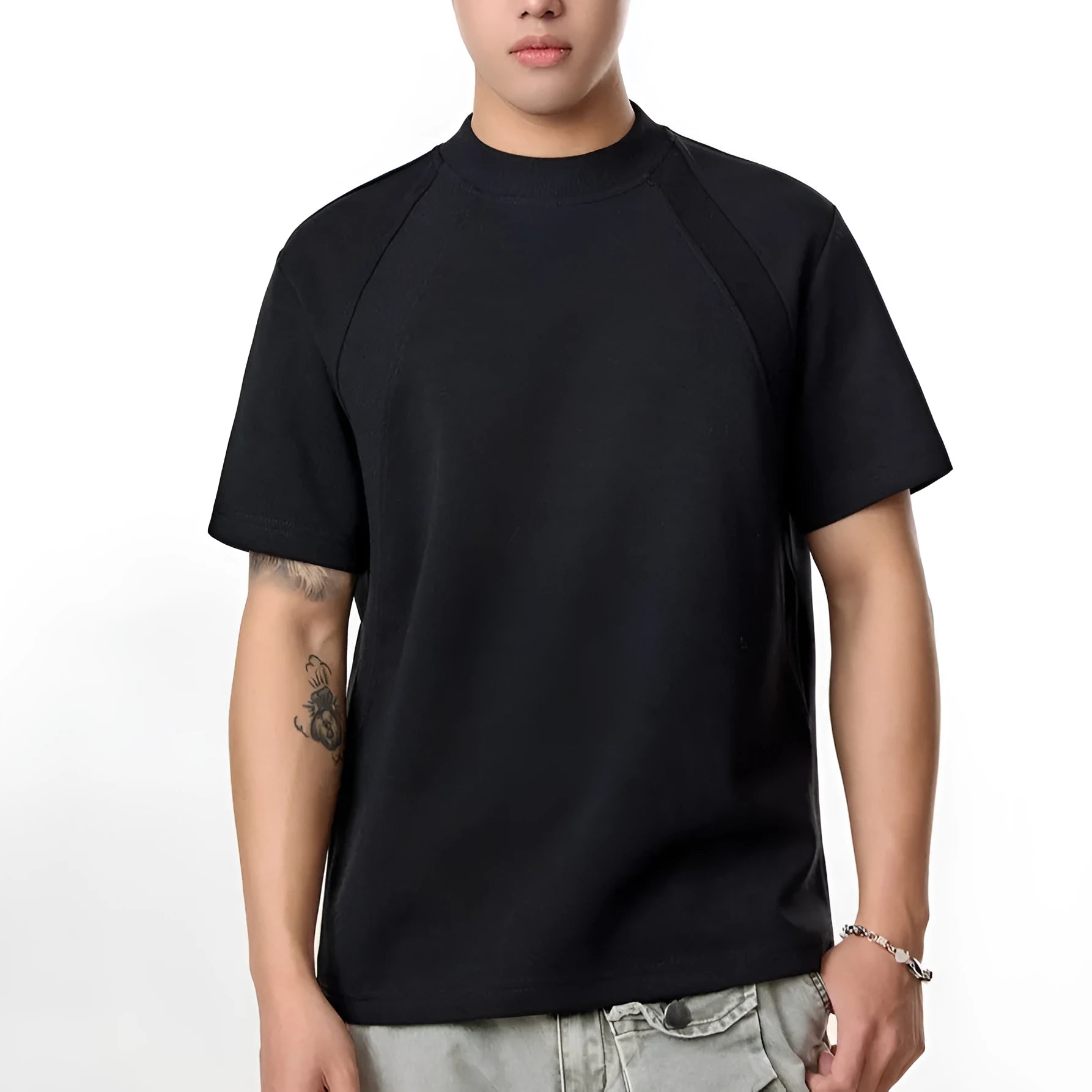 Black loose fit short sleeve top with air layer stitching detail on a hanger