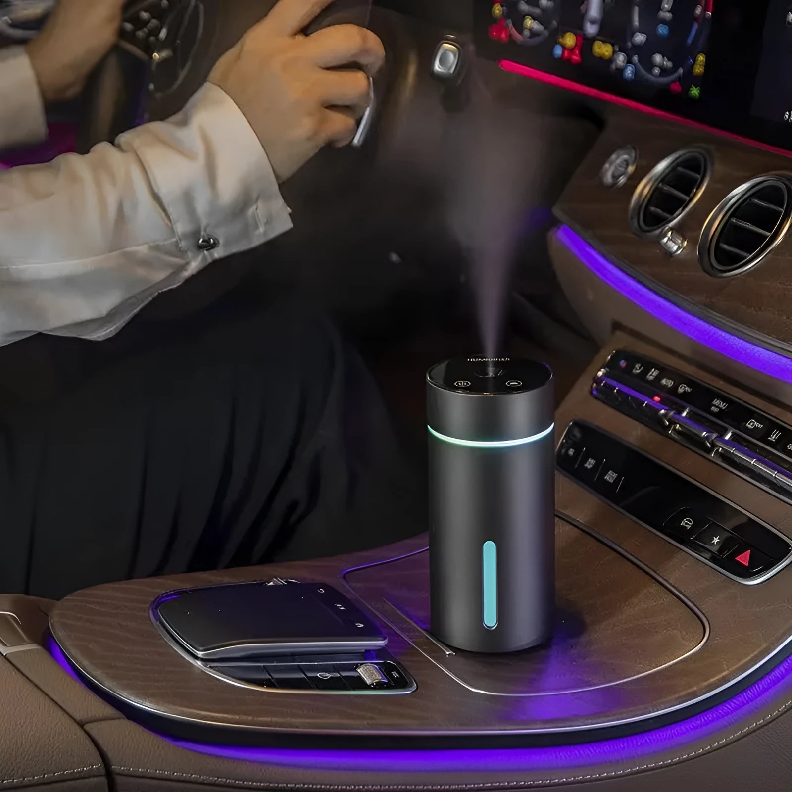 Aluminium portable car air humidifier and essential oil diffuser with multi-colour light on a black USB cable.