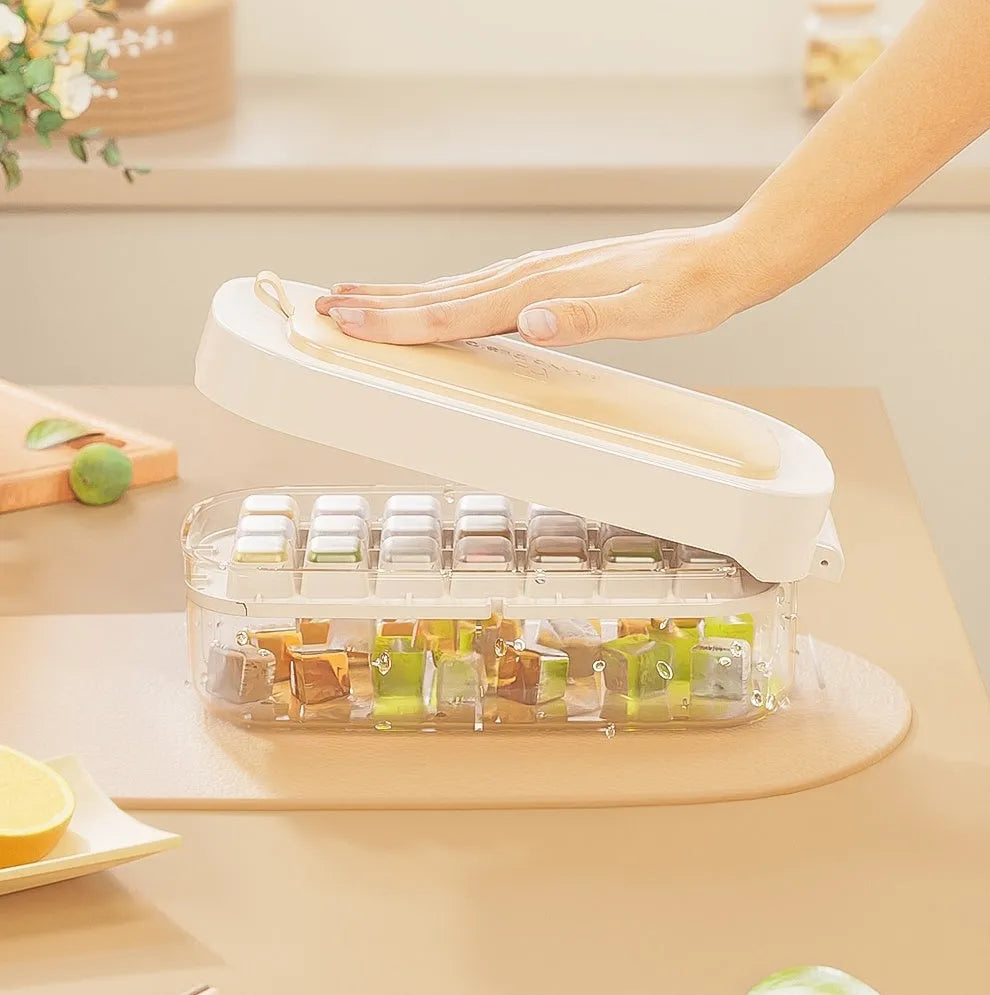 Blue high capacity ice cube tray with integrated storage for an ice shovel, showing the grid layout.
