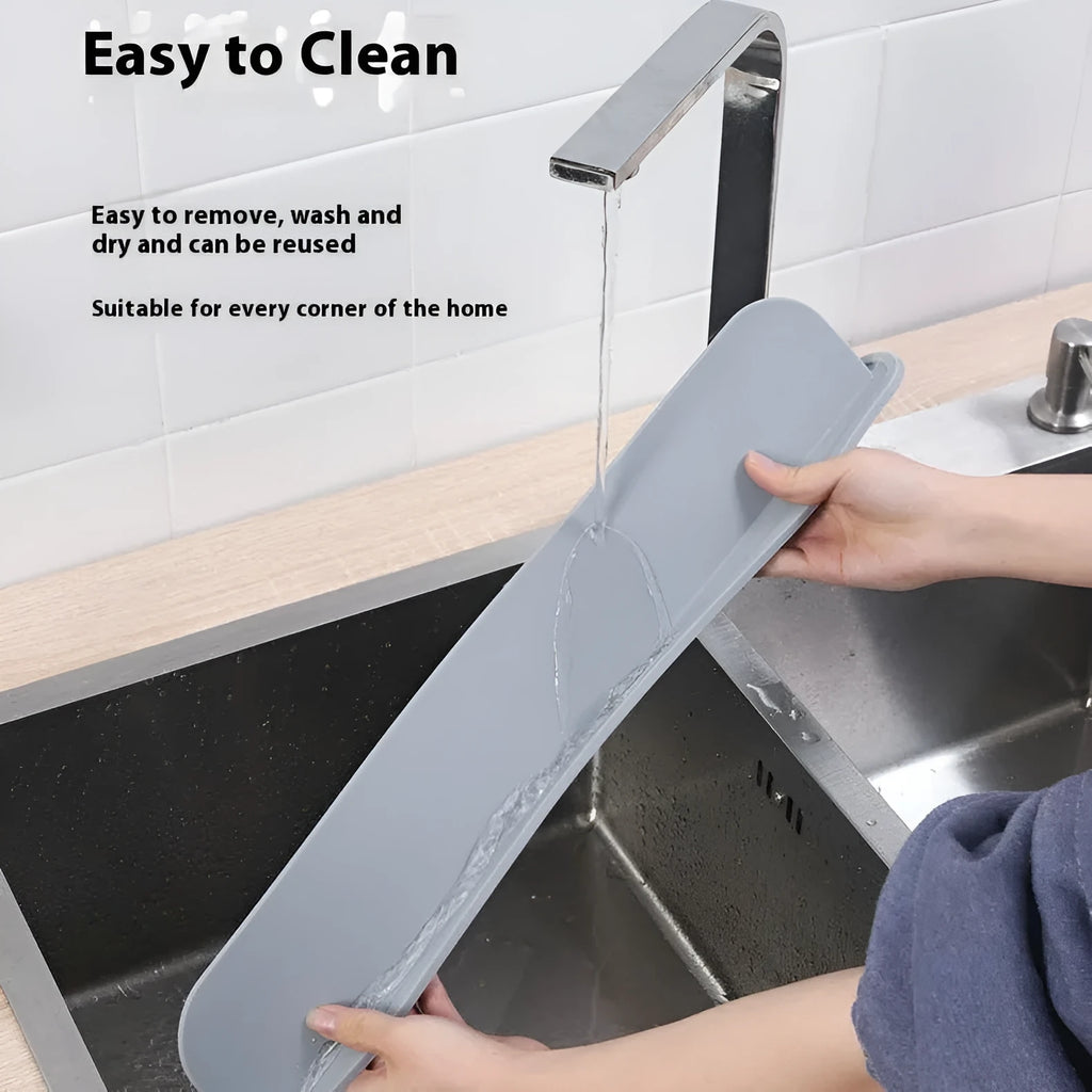 Grey silicone sink water blocking plate placed behind a kitchen tap