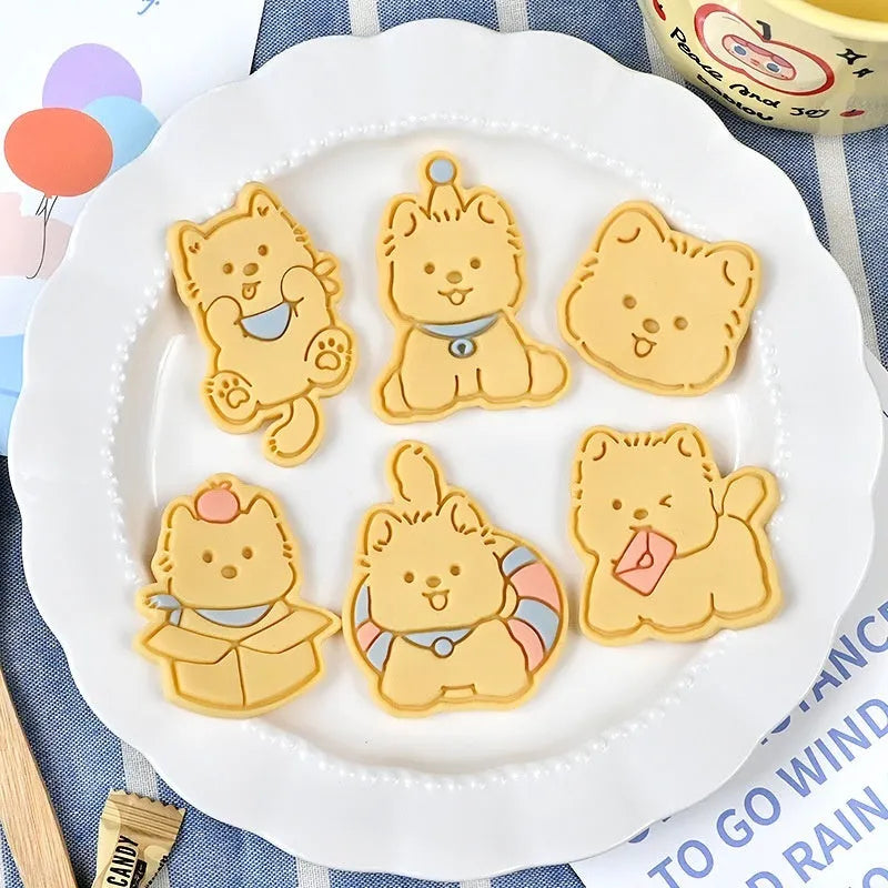 Plastic 3D cartoon puppy biscuit mould showing seven style variations including birthday hat and swimming ring designs