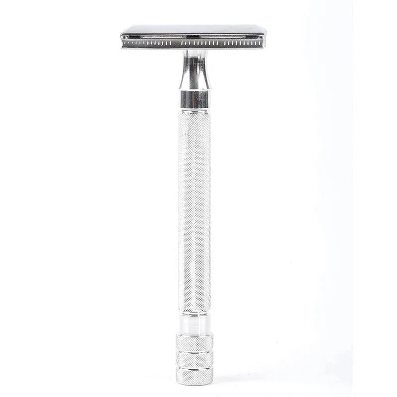 Traditional manual shaving kit showing a metal safety razor and a shaving brush on a dark background.