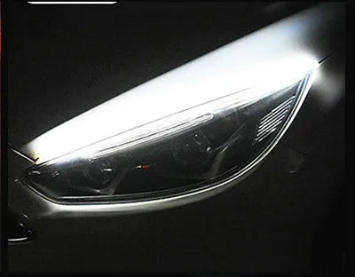 Car LED daytime running light strip with flowing turn signal indicator in silicone housing
