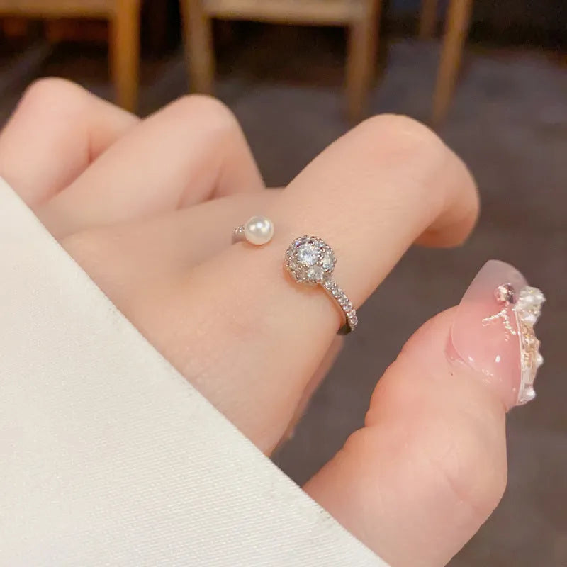 Open-end women's ring with round zircon and pearl elements in gold or silver real gold plating