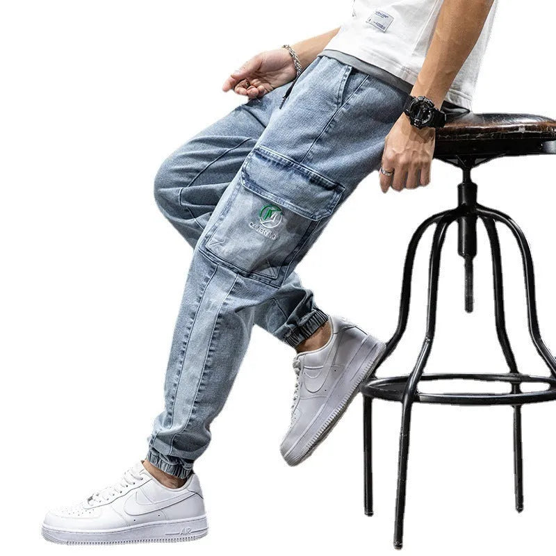 Man wearing grey-blue straight leg cargo jeans with micro elasticity and cargo pockets.