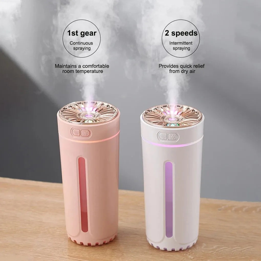 Black portable car humidifier with colourful LED lights showing mist output, placed in vehicle cup holder