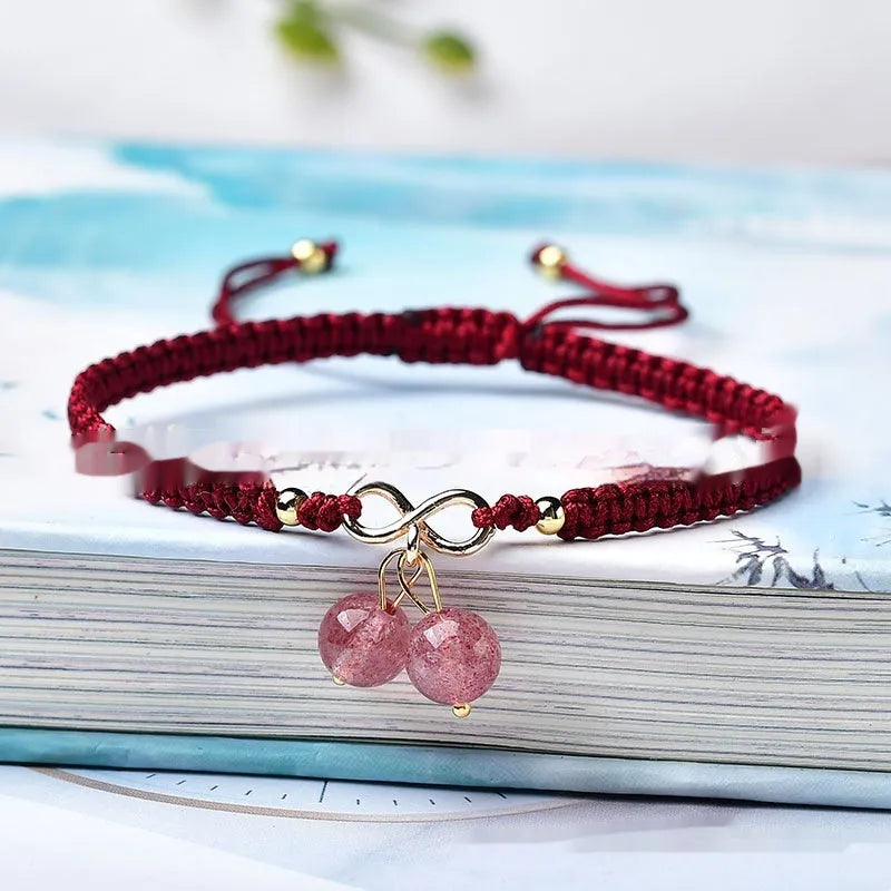 Women's natural strawberry quartz crystal bracelet with red cherry-shaped beads on a string.