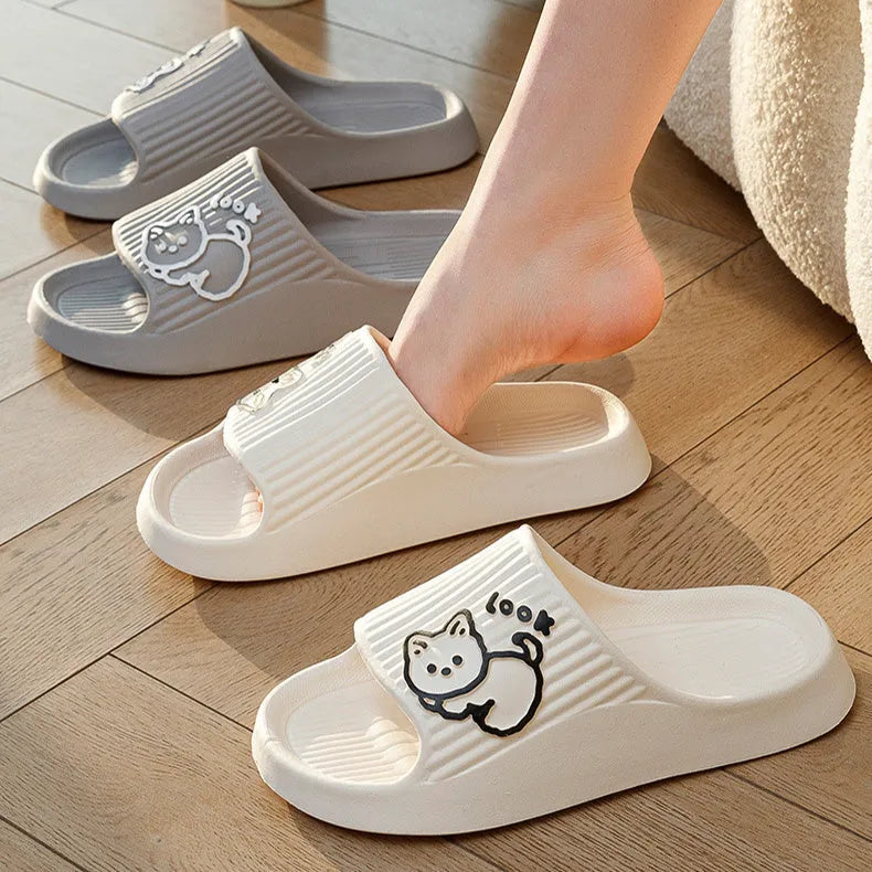 Women's cat platform slippers in pink with thick EVA sole, shown on a wooden floor.