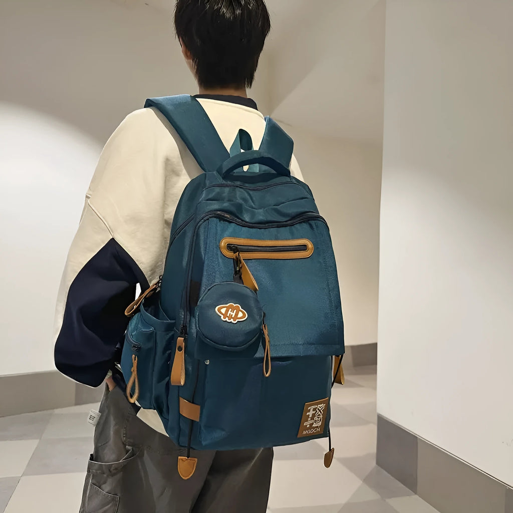 Large black nylon school backpack with curved shoulder straps, shown in a street style design for students.
