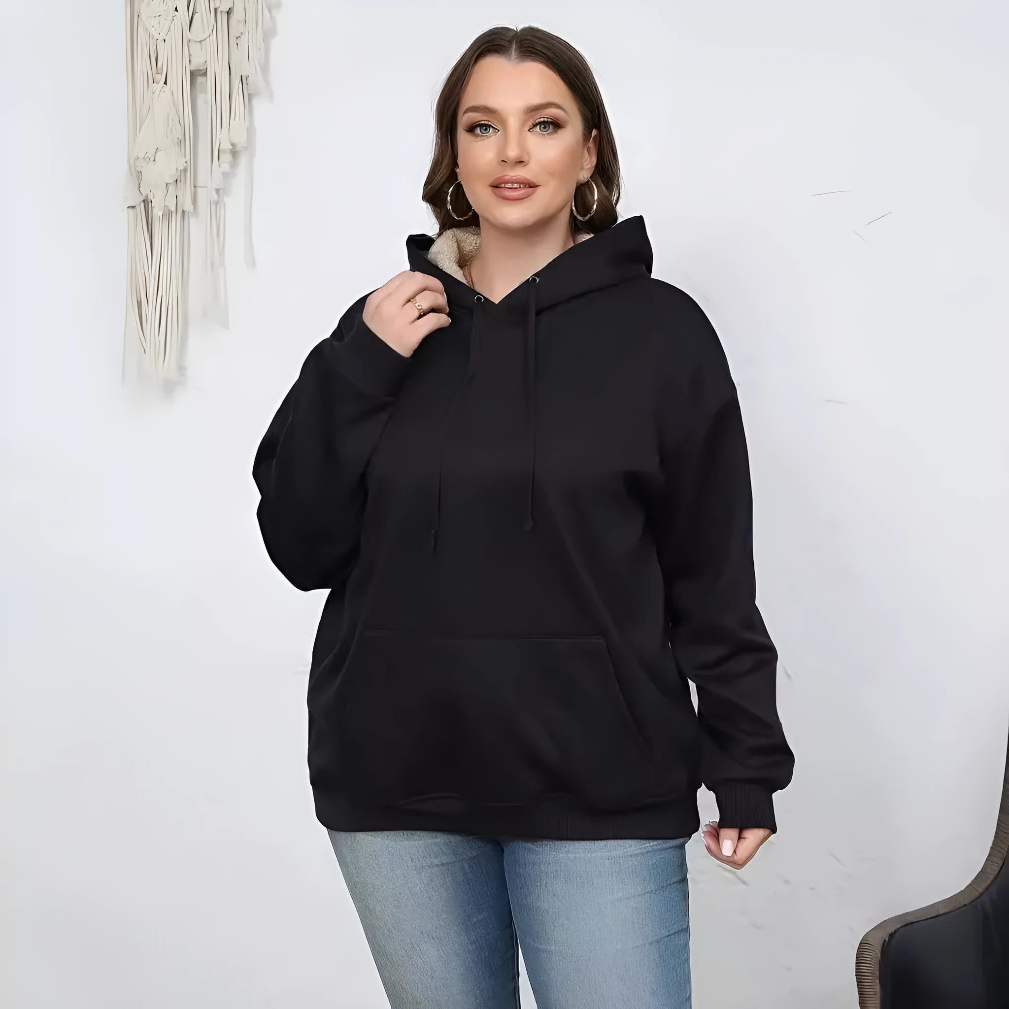 Women's black hooded sweater with a raised 3D pattern, featuring a loose fit and long sleeves.